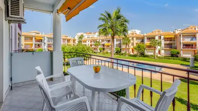 a table and chairs on a balcony with a view of condos at Serene Apartment W/ Balcony and Pool by LovelyStay in Quarteira