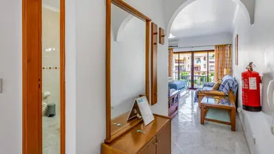 a living room with a fire hydrant and a mirror at Serene Apartment W/ Balcony and Pool by LovelyStay in Quarteira