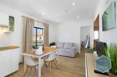 a kitchen and living room with a table and chairs at Vila Magna 109 - Dream Lodging in Albufeira