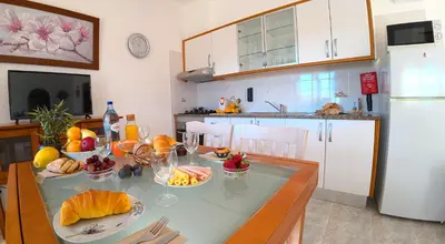a kitchen with a table with fruit on it at CH 1 e 2 Two Apartments Up To 10 Guests Casa da Horta, T1 & T2 in Albufeira
