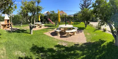 a park with several picnic tables and a playground at CH 8, 11 e 12 - Casa da Horta 3 x T 1 Apartments Up To 12 Guests in Olhos de Água