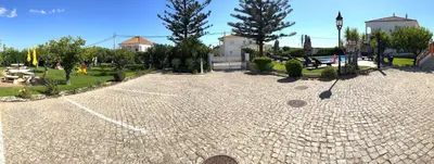 a cobblestone courtyard with trees and a building at CH 8, 11 e 12 - Casa da Horta 3 x T 1 Apartments Up To 12 Guests in Olhos de Água