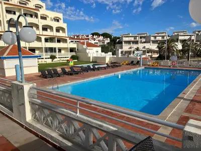 a large swimming pool in front of a building at Albufeira studio Bellevista in Albufeira