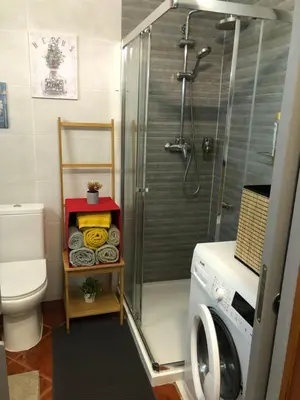 a bathroom with a shower and a washing machine at Albufeira studio Bellevista in Albufeira
