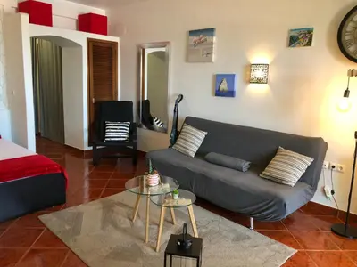 a living room with a couch and a table at Albufeira studio Bellevista in Albufeira