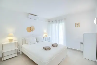 a white bedroom with a white bed and a window at Modern Oasis 500m Beach with AC WiFi Pool in Albufeira
