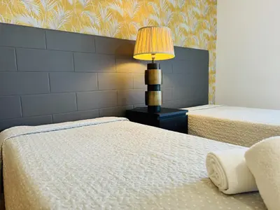 a bedroom with a bed and a desk and a window at Marina Vilamoura - Aquamar 402 By Vilamoura Sun in Quarteira