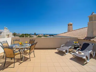 a patio with tables and chairs on a balcony at Apartment Penthouse Milea by Interhome in Patroves