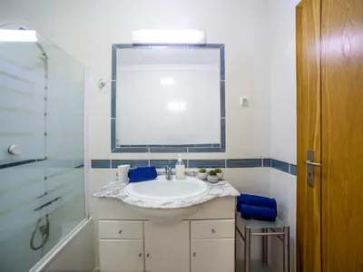 a bathroom with a sink and a mirror and a shower at Apartment Penthouse Milea by Interhome in Patroves