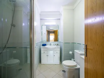 a bathroom with a toilet and a sink and a shower at Apartment Penthouse Milea by Interhome in Patroves