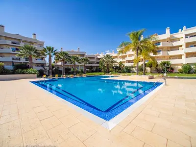 a swimming pool in front of a large apartment building at Apartment Penthouse Milea by Interhome in Patroves