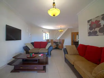 a living room with two couches and a table at Apartment Penthouse Milea by Interhome in Patroves