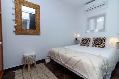 a bedroom with a bed and a mirror on the wall at Açoteias 203 in Albufeira