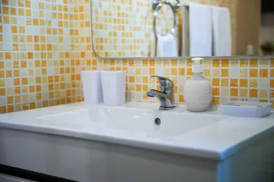 a bathroom sink with a soap dispenser and a mirror at Açoteias 203 in Albufeira