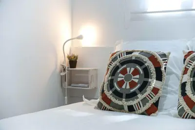 a bedroom with a bed with a dart pillow on it at Açoteias 203 in Albufeira