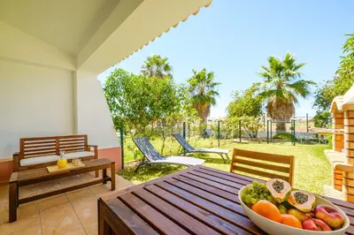 a bowl of fruit on a wooden table on a patio at Villa Baya - Great family complex with communal pool in Albufeira