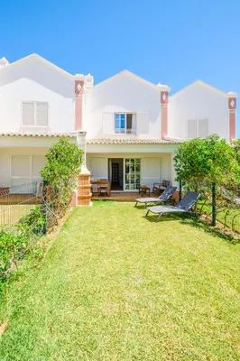 a house with a lawn in front of it at Villa Baya - Great family complex with communal pool in Albufeira