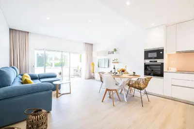 a living room with a blue couch and a table at Apartment Tanta - located at the gates of the old in Albufeira