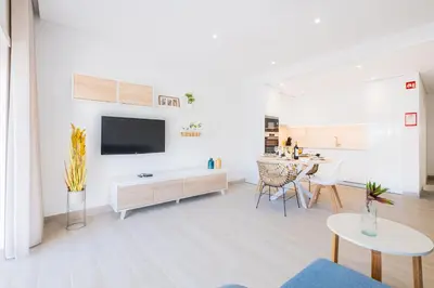 a living room with a tv and a table at Apartment Tanta - located at the gates of the old in Albufeira