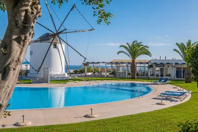 a windmill next to a swimming pool with a windmill at Apartment Vento in Albufeira