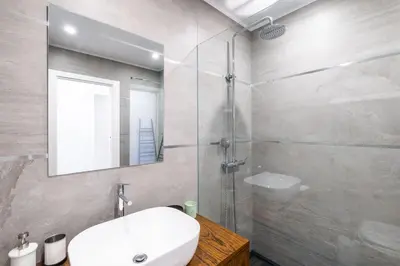 a bathroom with a white sink and a shower at Apartment Riu - Close to bars shops and restaurants in Albufeira