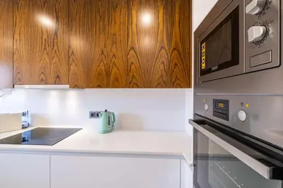a kitchen with a sink and a microwave at Apartment Riu - Close to bars shops and restaurants in Albufeira
