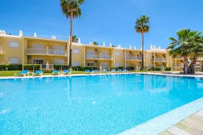 a large swimming pool in front of a building at Apartment Riu - Close to bars shops and restaurants in Albufeira