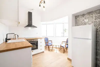a kitchen with a white refrigerator and a table at Apartment Santana - In the heart of Albufeira in Albufeira