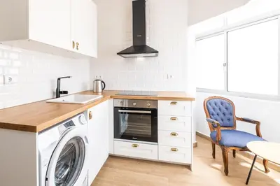 a kitchen with a washing machine and a washer at Apartment Santana - In the heart of Albufeira in Albufeira