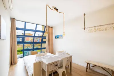 a bedroom with a bed and a table and a window at Apartment Mayah - Albufeira marina in Albufeira