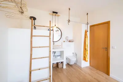 a bathroom with a ladder next to a toilet at Apartment Mayah - Albufeira marina in Albufeira