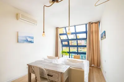a dining room with a table and a large window at Apartment Mayah - Albufeira marina in Albufeira