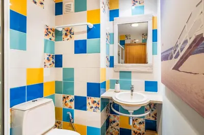 a colorful bathroom with a toilet and a sink at Apartment Mayah - Albufeira marina in Albufeira
