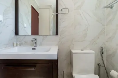 a bathroom with a white sink and a toilet at Marina Vision Vilamoura in Vilamoura
