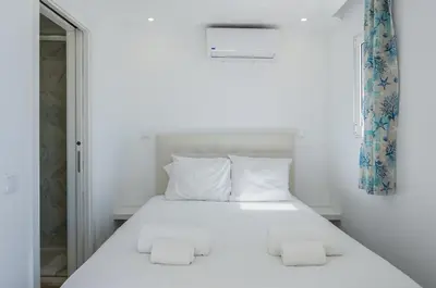 a bedroom with a white bed with white pillows at Marina Vision Vilamoura in Vilamoura