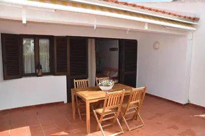 a bedroom with a large white closet and a bed at Casa Linda da Praia do Alfamar in Albufeira