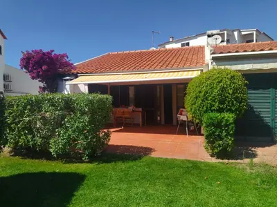 a table with a red table cloth and bowls on it at Casa Linda da Praia do Alfamar in Albufeira