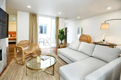 a living room with a couch and a table at Green Algarve Gem Spacious 2 BDR By Misha's Place in Faro