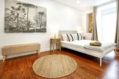 a bedroom with a bed and a couch and a table at GREEN BLISS IN FARO, Central One-Bed Oasis in Faro