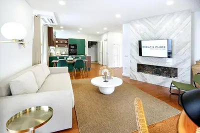 a living room with a white couch and a fireplace at GREEN BLISS IN FARO, Central One-Bed Oasis in Faro