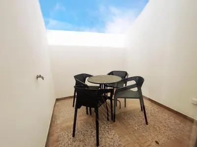 a table and four chairs in a room at GREEN FARO, MODERN DUPLEX with A BLISS TERRACE in Faro