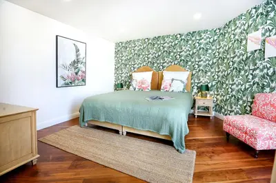 a kitchen and living room with a table and chairs at Green & Gorgeous - 3 bedroom Getaway in the Heart in Faro
