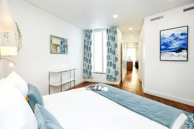 a bedroom with a bed and a blue rug at Green & Gorgeous - 3 bedroom Getaway in the Heart in Faro