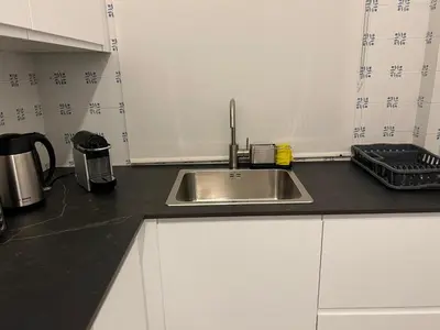 a kitchen counter with a sink in a kitchen at Pateo AL Albufeira in Albufeira