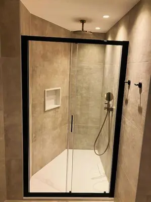 a shower with a glass door in a bathroom at Vila Lana - Heated pool - Sea view - Two independent floors in Faro