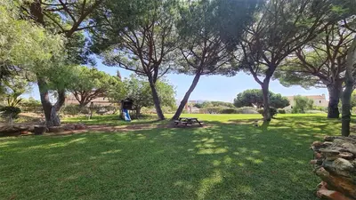 a person standing in a park with a picnic table at Green Valley 03- CleverDetails, Monte Verde, lux, distant sea view, 3 bedroom, 4 saltwater pools in Vilamoura