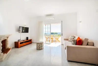 a living room with a couch and a fireplace at Marina Vista Retreat in Albufeira