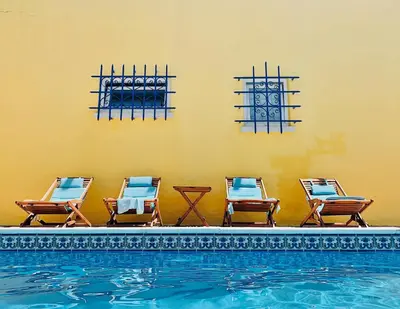 a group of chairs sitting next to a swimming pool at Fashion Villa in Vilamoura with Private Pool in Quarteira