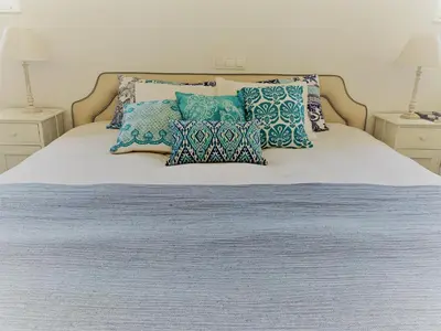 a bed with blue and white pillows on it at Fashion Villa in Vilamoura with Private Pool in Quarteira