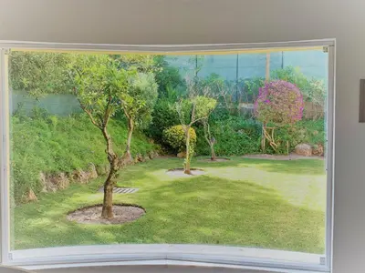 a window with a view of a yard with two trees at Fashion Villa in Vilamoura with Private Pool in Quarteira